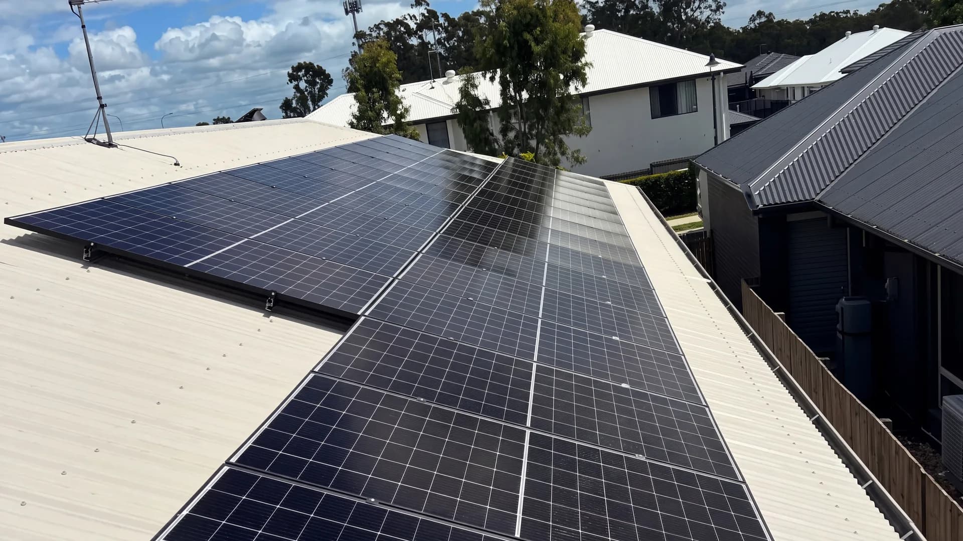 A long run of solar panels along the ridge of a residential metal roof